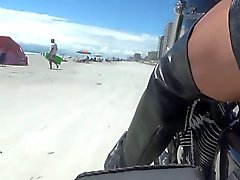 sexy leather biker in thigh boots on the beach